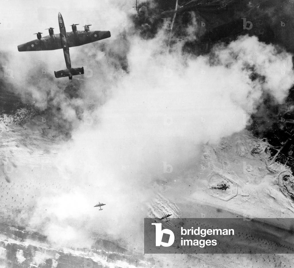 A four engine Halifax bomber attacking fortified positions at Calais in Northern France during a heavy raid by the RAF in World War Two, 25th, September 1944 (b/w photo)