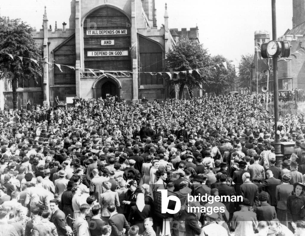 A huge crowd in Broadgate listening to the Prime Minister's radio announcement of the official end of the European war, 8th May 1945 (b/w photo)