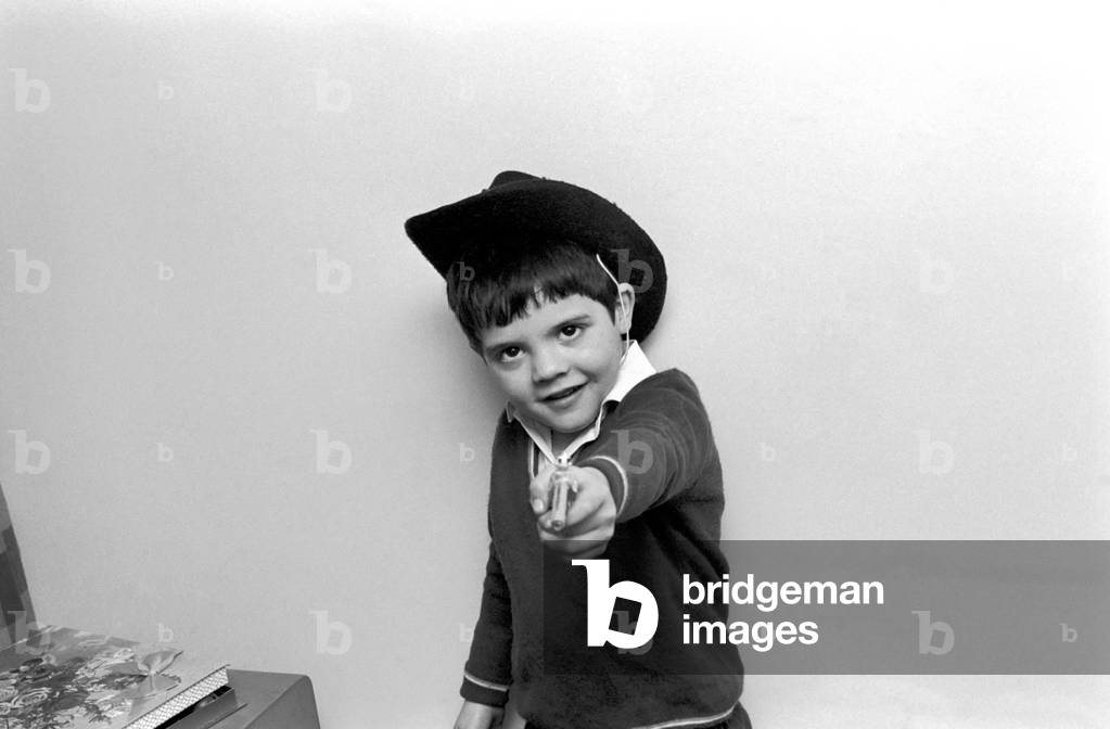 Little abandoned boy who calls himself George Mason settles down in a children's home in Camden, London. Our photographer is firmly in the sights of George's toy gun. December 1969