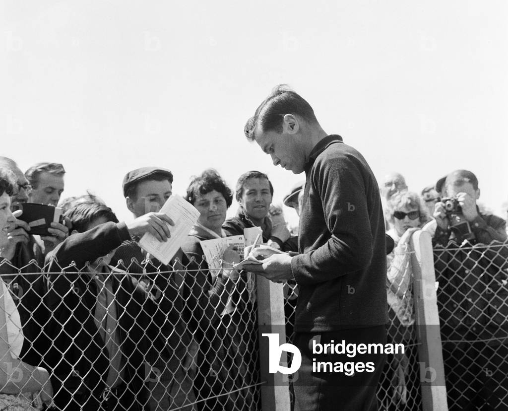 Rider Gary Hocking signs autographs for fans. 5th June 1962 (b/w photo)