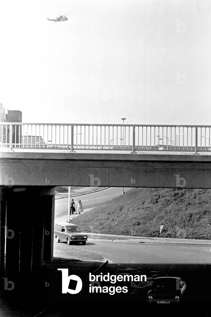 General scenes of traffic scenes in Newcastle - cars going under the road with a helicopter flying in the sky, 20 June 1979 (b/w photo)