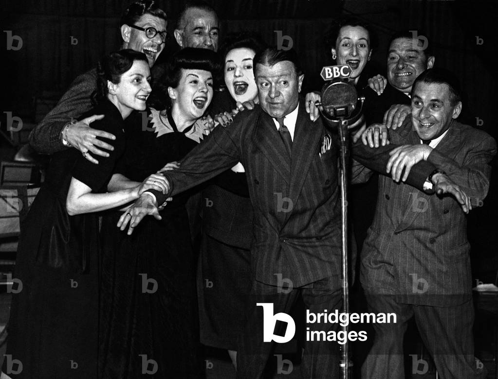 Tommy Handley centre holds back l to r Joan Harben, Derek Guyler Unknown male, Lind Joyce , Hattie Jacques, Unknown female Fred Yule and Jack Train, c. 1947 (b/w photo)