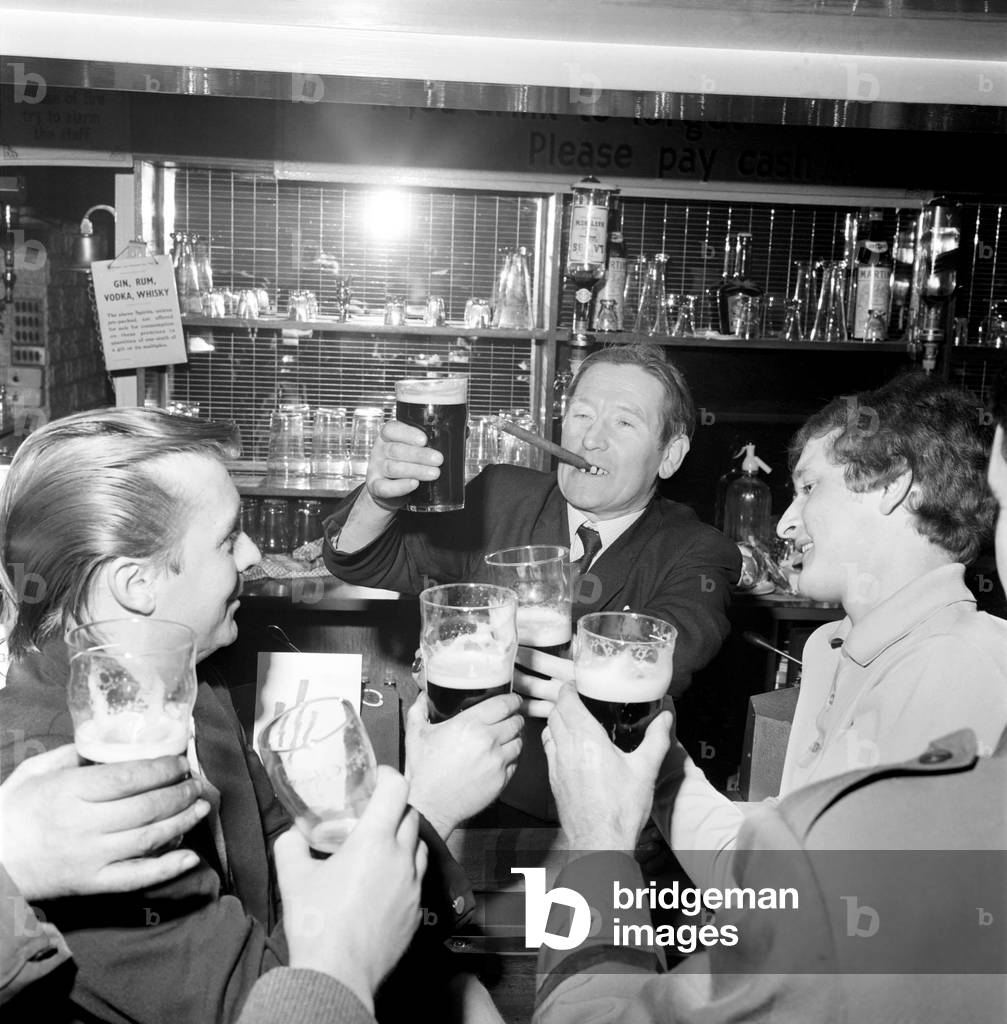 Drinking Pubs. Licencee of the Jubilee Inn at White Lane, Salford, Mr. Sidney Harrison, says 'cheers' to his customers as he raises his pint to toast the launching of his cut-price drinks plan. November 1969