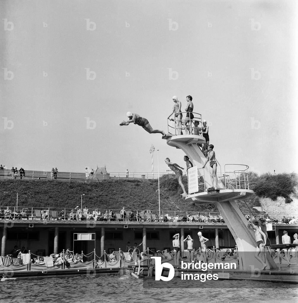 Taking The Plunge... 75 year old Molly Pendleton diving from a 16ft. 6in diving board. Brighton, East Sussex, 26th August 1960 (b/w photo)