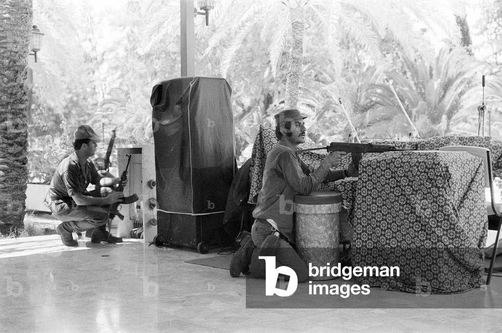 Greek Cypriot soldiers inside the Ledra Palace Hotel, during the Turkish invasion of Cyprus. The Ledra Palace Hotel became the centre of fighting with the Greek Cypriot soldiers keeping residents and journalists in the hotel. 22nd July 1974 (b/w photo)