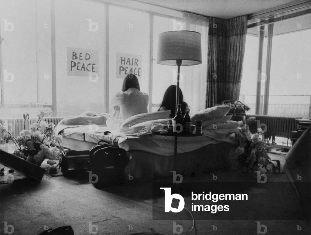 John Lennon and his wife Yoko Ono are having a weeks love-in their room at the Hilton Hotel, Amsterdam. They will stay in bed for seven days - with fruit, flowers and peace signs, March 1969