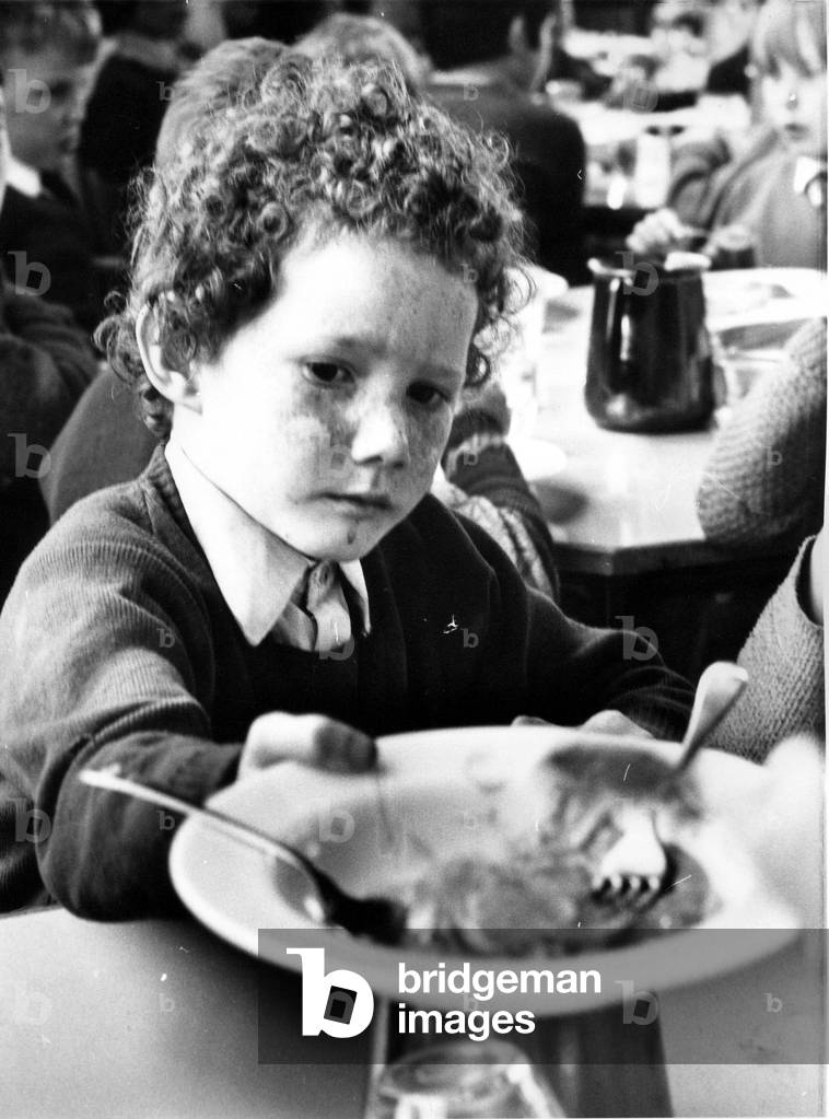 Please sir, I want some more, this little boy has enjoyed his school meal, c.1970 (b/w photo)