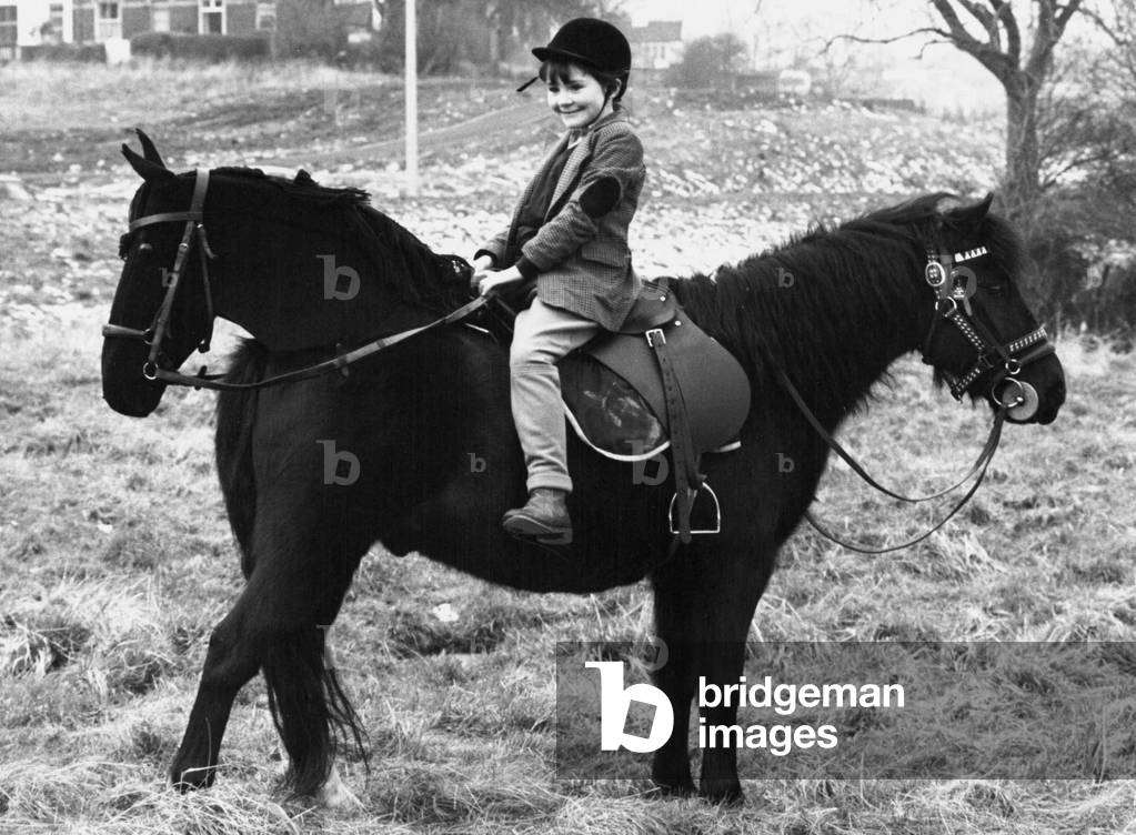 A little girl sits on what seems to be a two headed pony, 27th June 1978 (b/w photo)