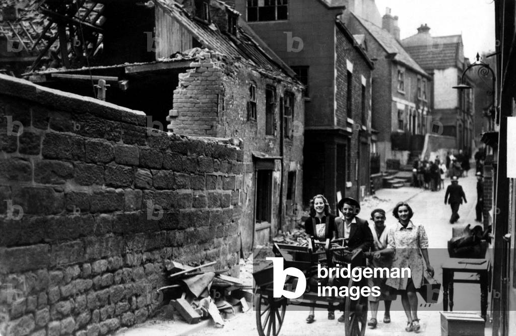 Second World War - The ruins after a German air raid on a North East of England town. People remove their belongings from bomb damaged houses, c. 1942 (b/w photo)