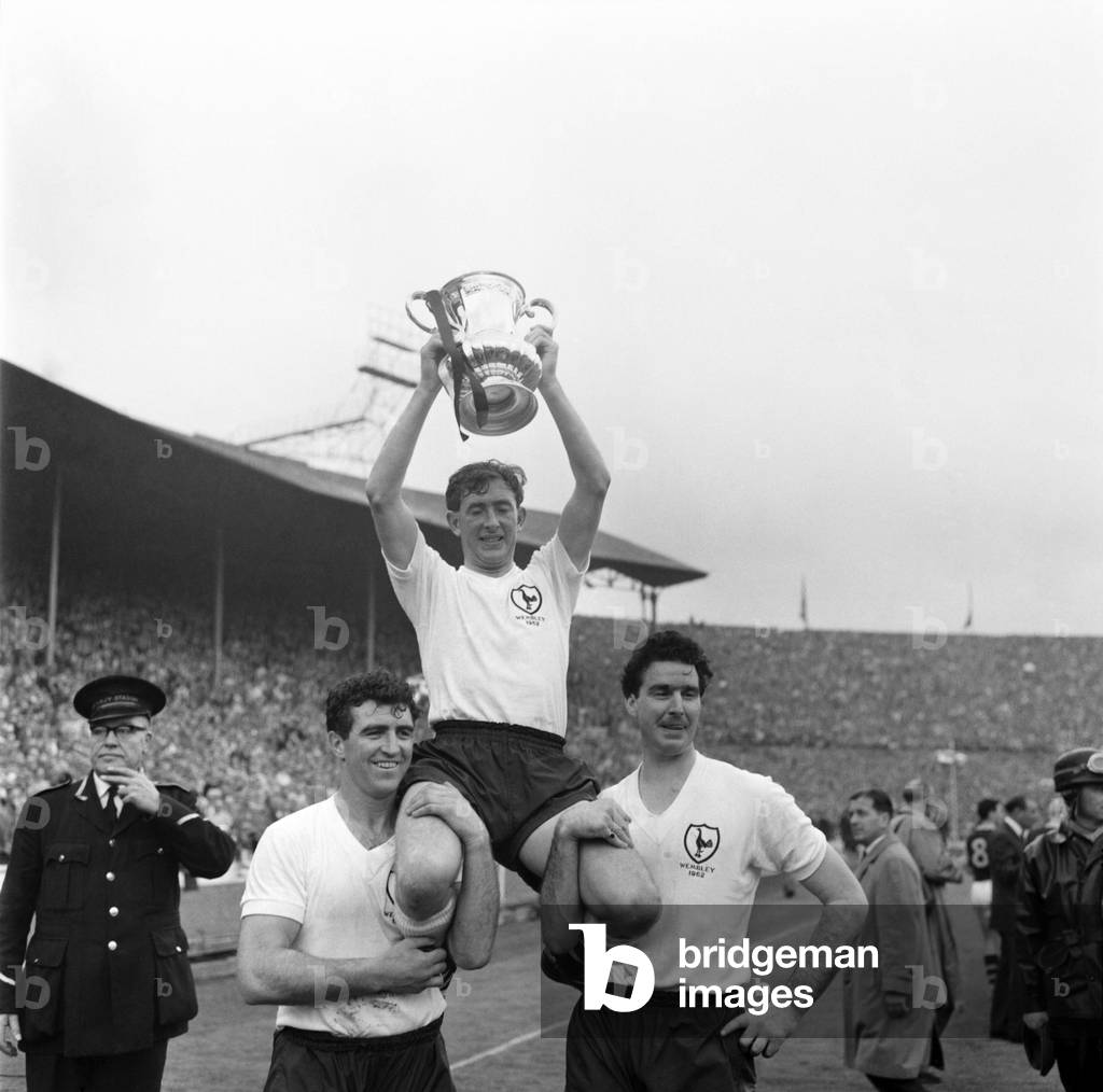 FA Cup final at Wembley Stadium. Tottenham Hotspur 3 v. Burnley 1. Spurs captain Danny Blanchflower sits on the shoulders of teammates Bobby Smith and Maurice Norman as he holds aloft the trophyMay 1962 Q3891A-009 (photo)