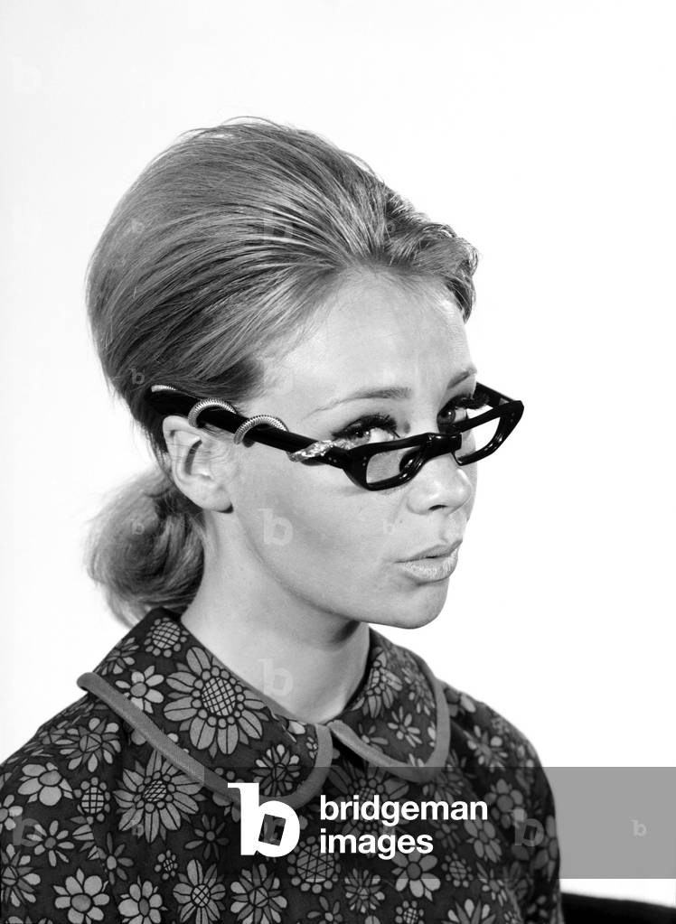 Clothing: Fashion: Spectacle Frames: Woman seen here modelling the latest fashionable spectacle frame designs. Model: Marilyn Rickard. 1966 (b/w photo)