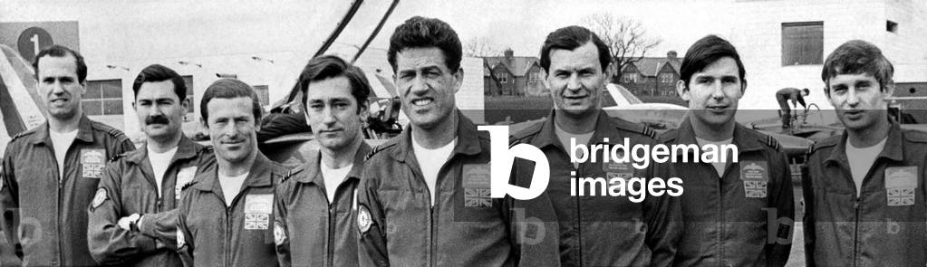 Squadron Leader Dennis Hazell (centre), pictured with his fellow Red Arrows pilots. The RAF's Red Arrows aerobatic team burst into the sky above Newcastle Airport with an off the cuff demonstration of their terrifying skills. They raced across the airport, skimming the ground, with a dense cloud trailing behind then, then burst into a 'star shell' flying up unto the air in every direction. All this after a 350 mile flight from their base in Kent, which the team's 10 Folland Gnat jets devoured in a quick, 38-minute trip. The team was in Newcastle to announce the start of the year's season of displays. Eighty-five displays were planned, including their 500th since the squadron was formed in 1965. After refuelling at the airport, the Red Arrows gave their show, then raced off again. They were due to return in the summer for displays at Newcastle, Sunderland and Teesside. 16/04/1970 (b/w photo)
