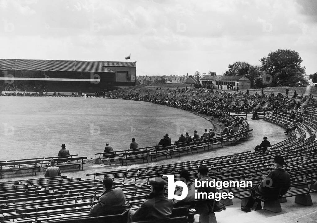 Spectators watching the action at Headingly, the ground of Yorkshire Cricket Club in Leeds. c.1935 (b/w photo)