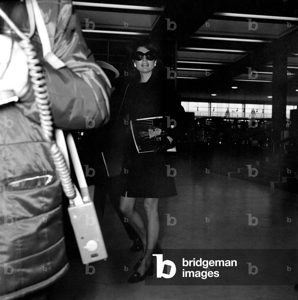 Mrs. Jacqueline Kennedy Onassis arrives at Heathrow Airport by Olympic Airways, on her way to the USA on Pan American Airways.