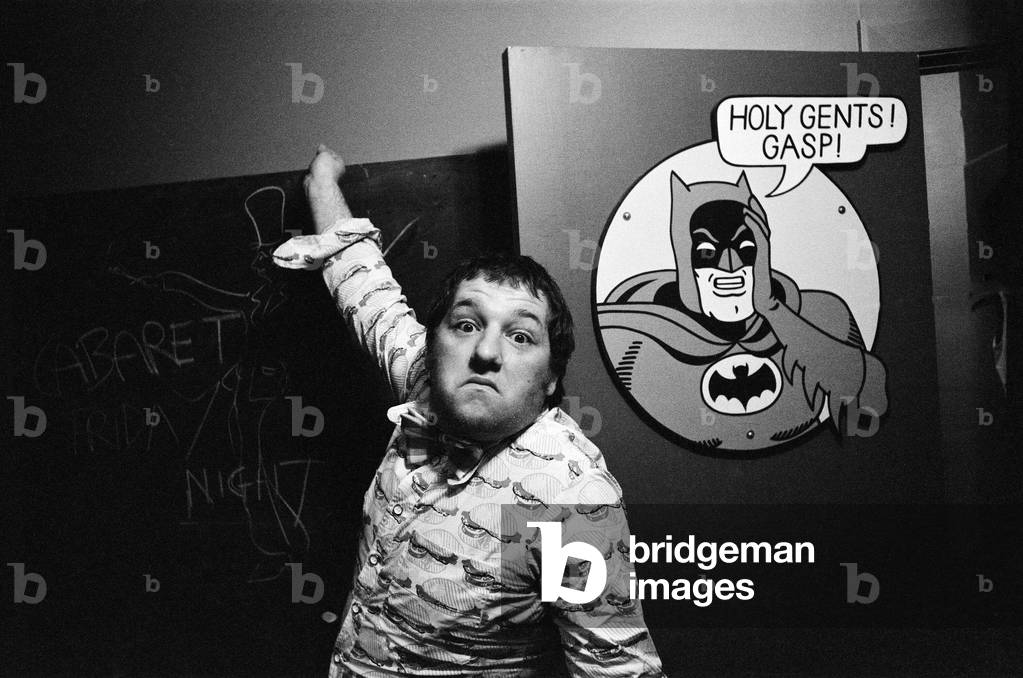 Tommy Roberts, owner of Mr Freedom's boutique and restaurant, pictured outside the Batman gents toilets where customers can draw what they want on a blackboard. The restaurant is in the basement of Mr Freedom clothing boutique, 20 Kensington Church Street, London. 30th July 1971 (b/w photo)