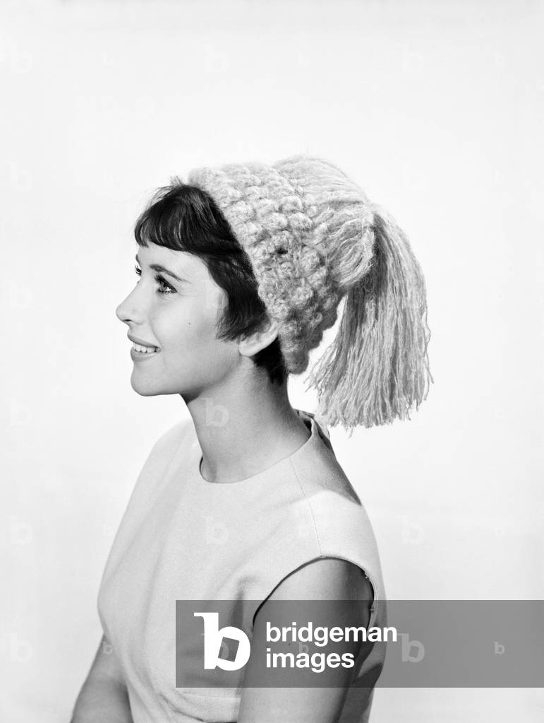 Model Ann Cave wearing knitted hat, c. 1960 (b/w photo)
