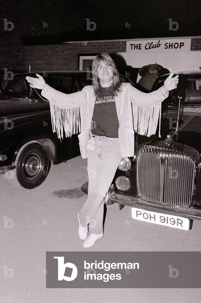 Black Sabbath singer Ozzy Osbourne poses next to a car after performing in concert August 1981