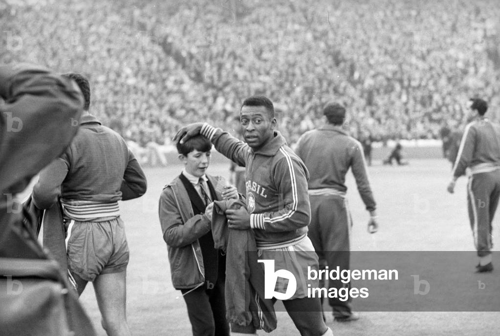 Scotland v Brazil International Friendly at Hampden Park, 25th June 1966. Pele gives a young autograph hunter a pat on the head. .. and his signature. Final score:Scotland 1-1 Brazil (photo)