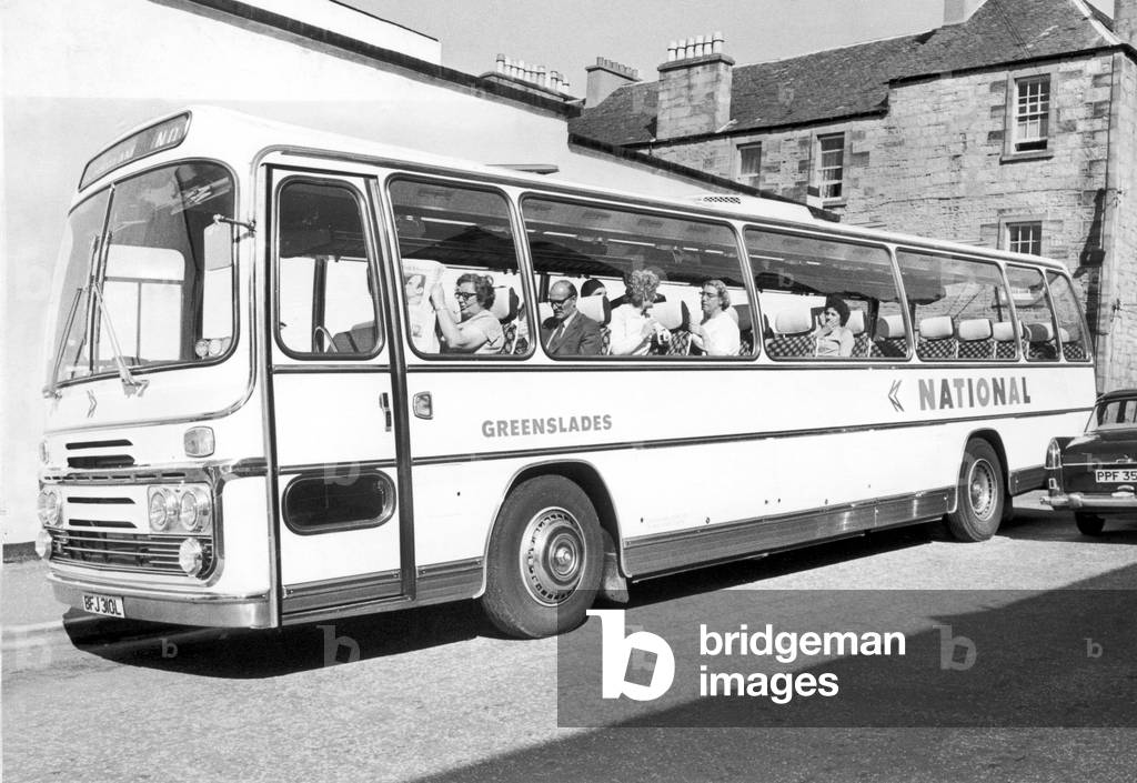 Fire at the Esplanade Hotel, Oban, July 24th 1973. Picture shows a coach of holiday makers leaving Oban with 23 passengers aboard, there are empty seats at the back; 9 people are dead and 10 in hospital due to the hotel fire. 26th July 1973 (b/w photo)