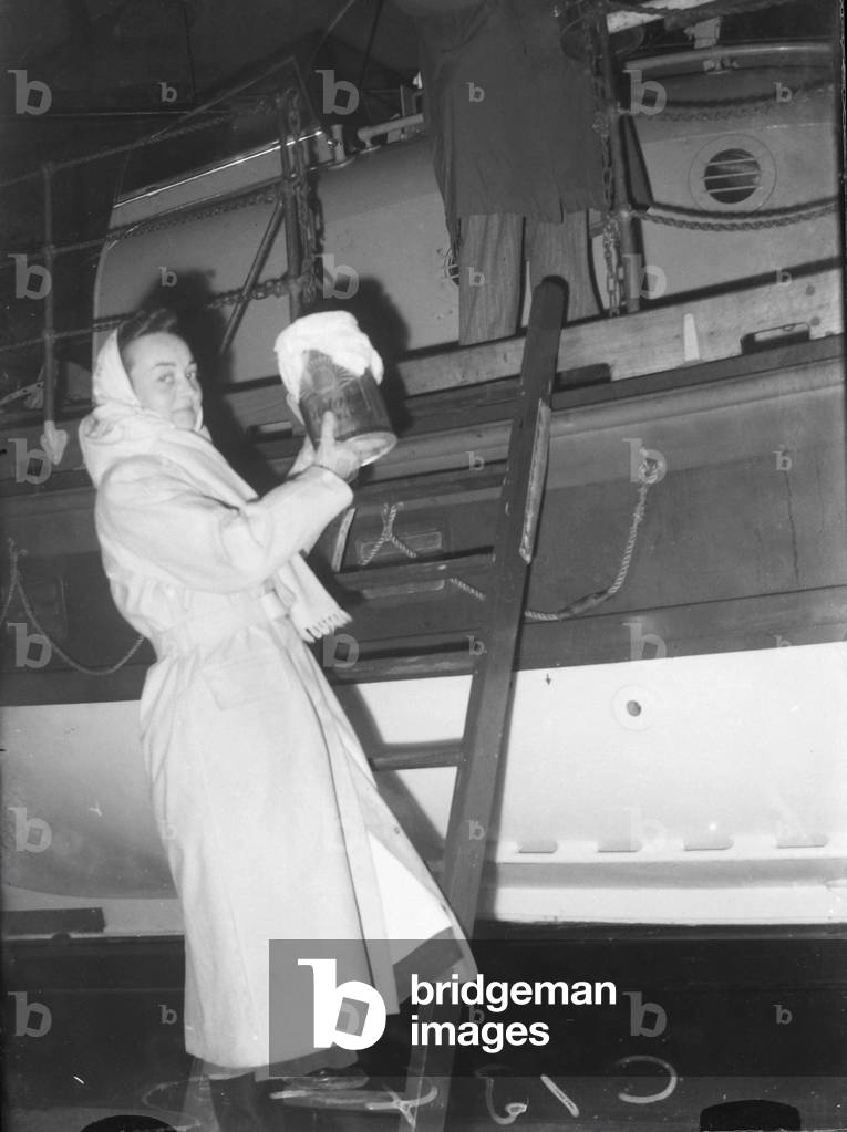 Sister Clevely stepping aboard the SENNEN lifeboat, January 1952 (b/w photo)