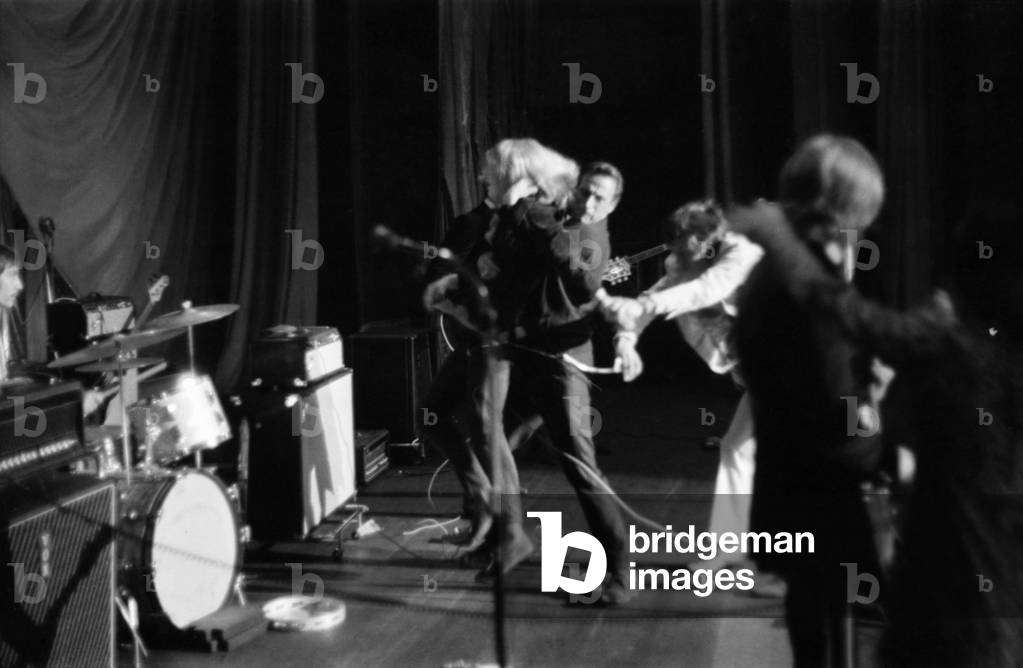 Rolling Stones Concert in Manchester. Sequence: A girl rushes on stage Ð pulls Mick Jaggers hair, then she is taken off stage by officials and general scenes. October 1966 W09171-001