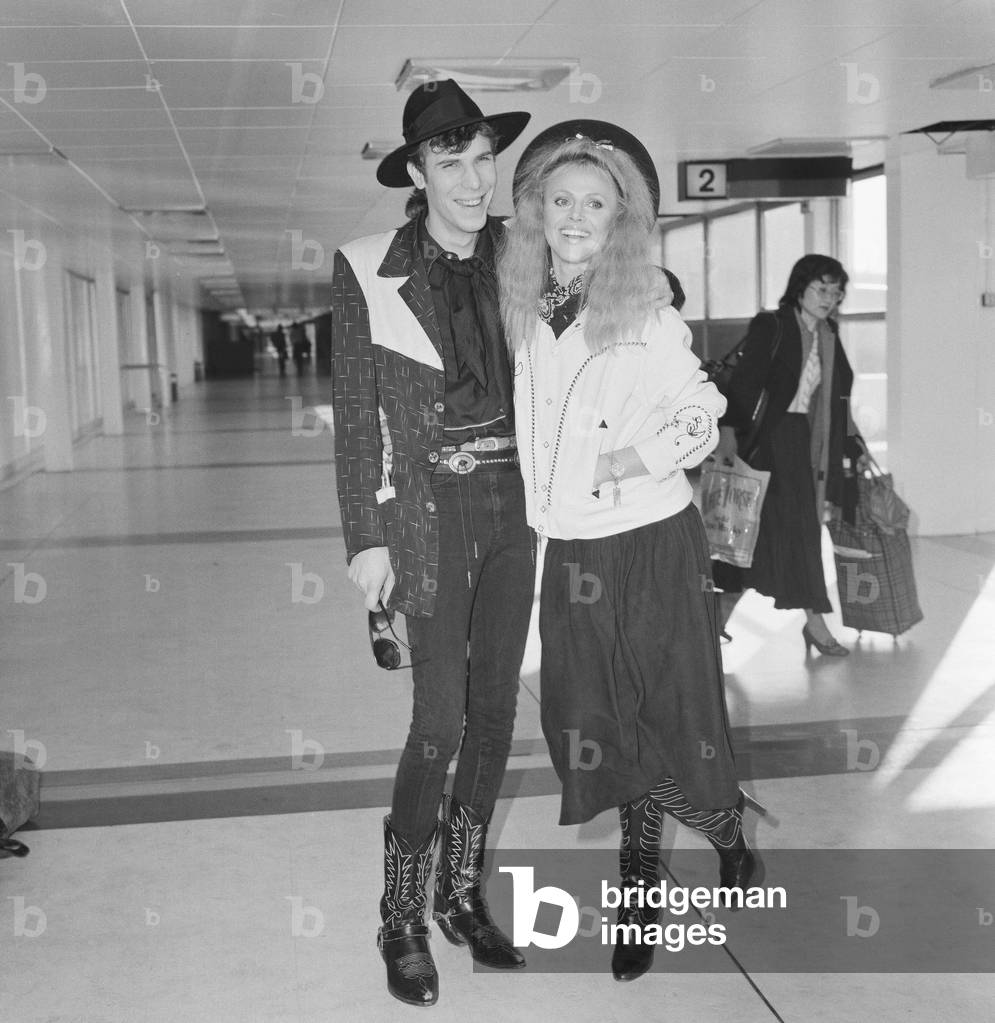 Britt Ekland with boyfriend Slim Jim McDonnell at Heathrow Airport. 16th November 1982.