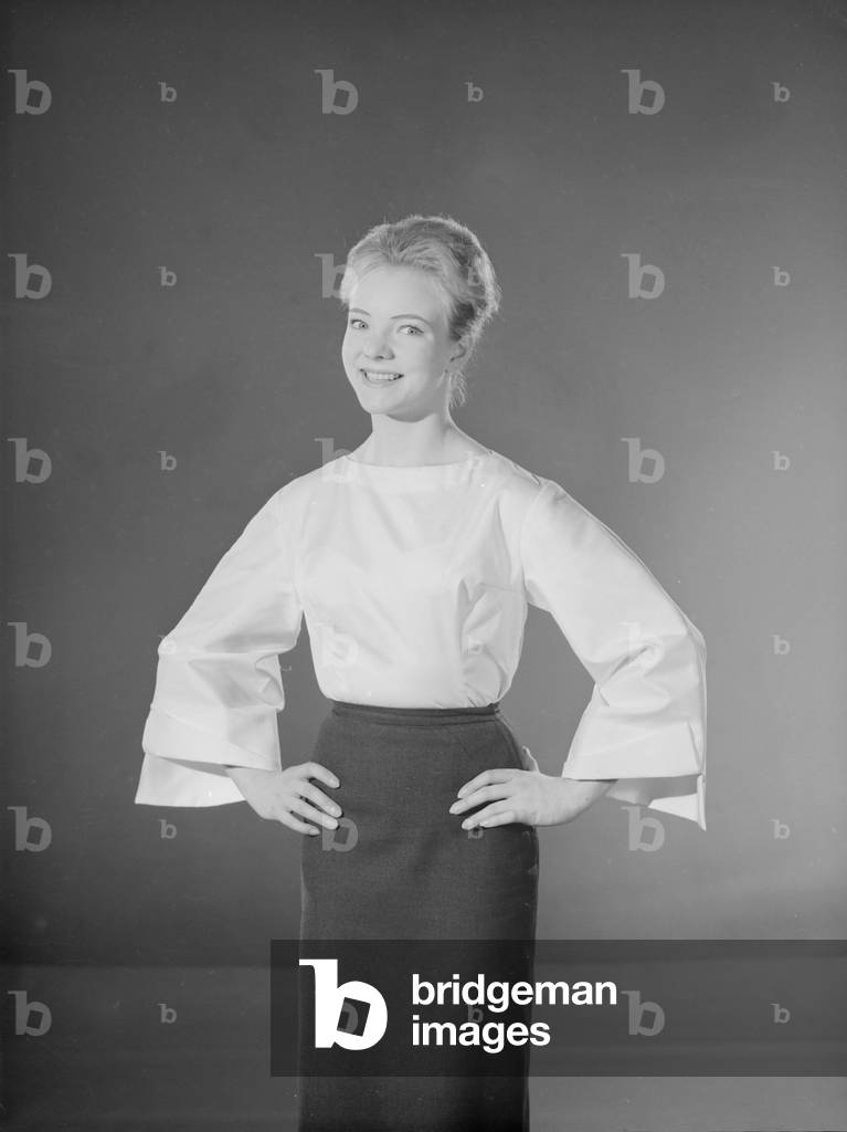 Model Valerie Hollman wearing white blouse and dark skirt, 03/09/1960 (b/w photo)