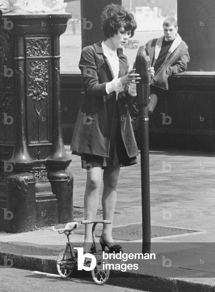 Sue Lloyd actress puts money in a parking meter May 1967
for her mini bicycle on the Embankment in London