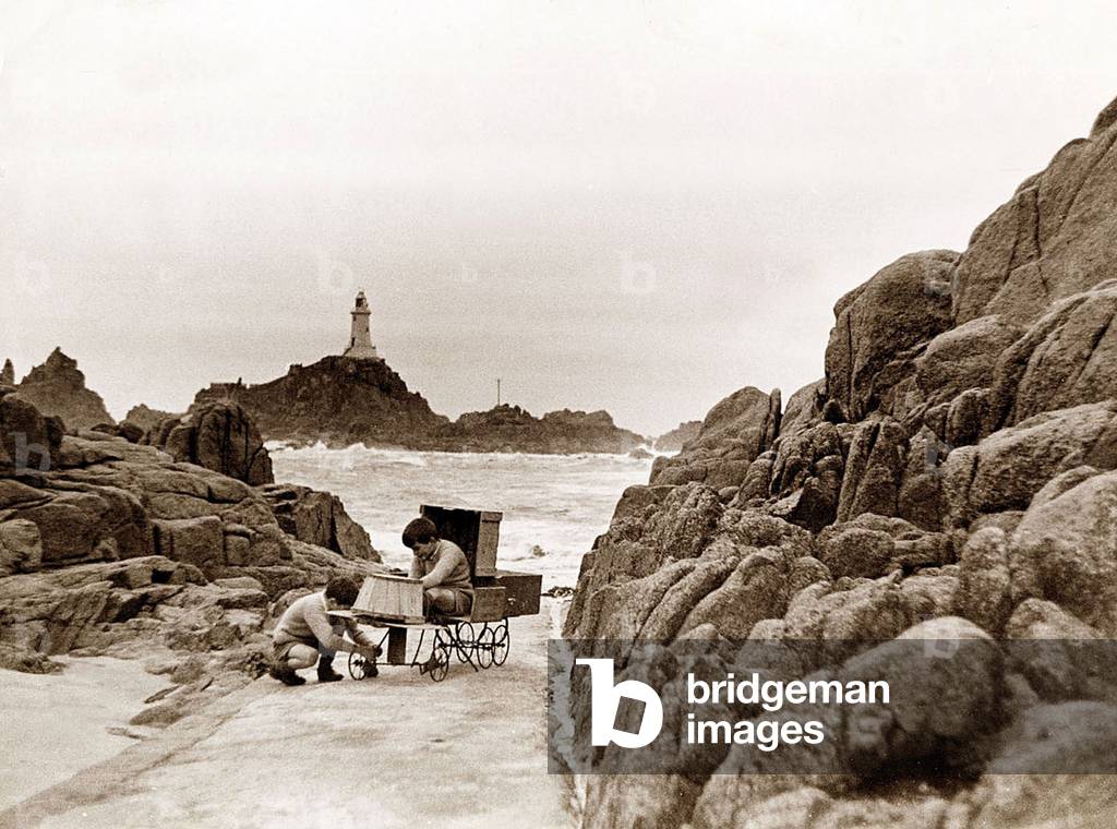 The two sons of the Corbiere Lighthouse keeper play on the causeway, February 1935 (b/w photo)