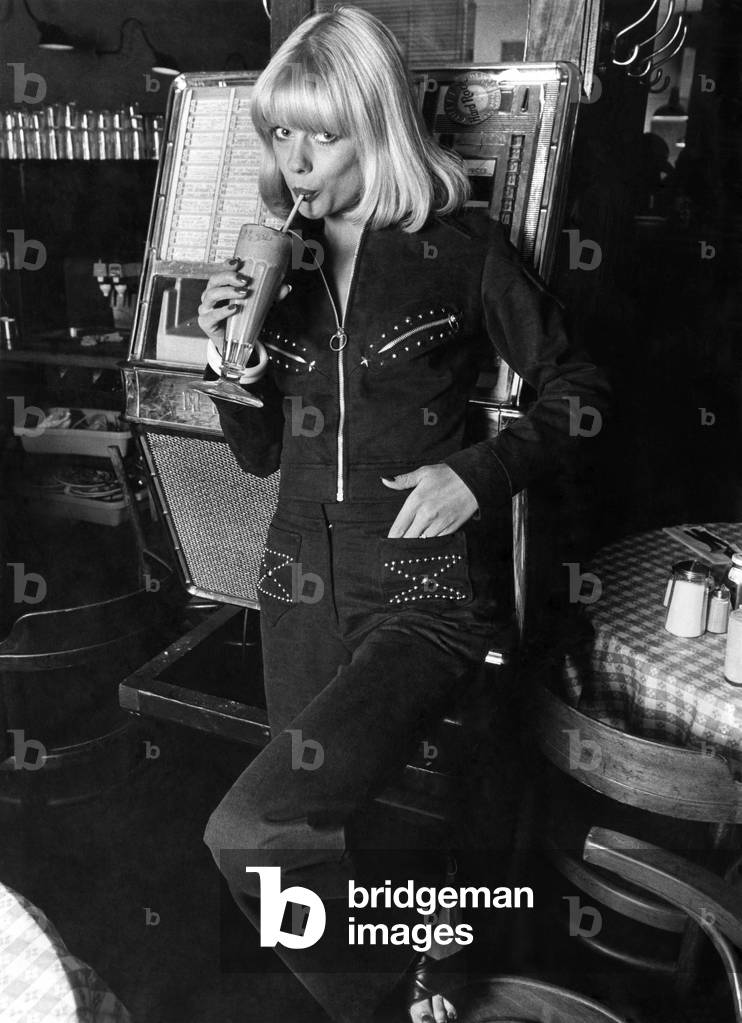 Sultry, sexy black brushed cotton pants suit with zippers and studs. Battledress-style jacket tops the flared pants. By Gay Girl
September 1972