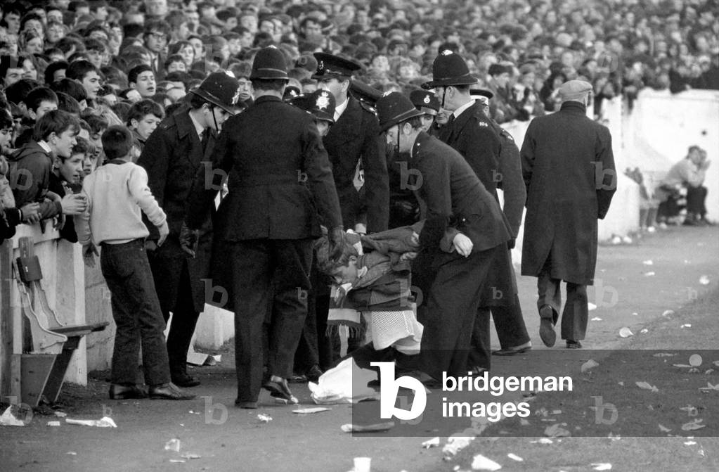 English League Division One match at Highfield RoadCoventry City 1 v Manchester United 2. Troublemaker is escorted out of the ground by policeNovember 1969 (photo)