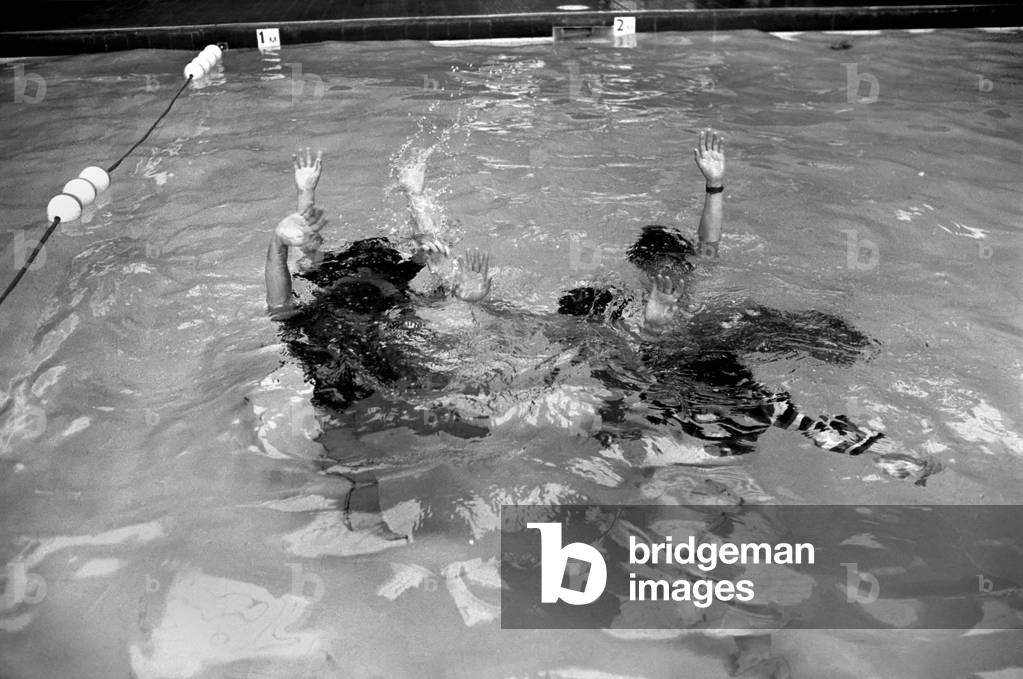 The Bay City Rollers celebrate their chart success with a quick dip in the pool, 11th March 1975 (b/w photo)