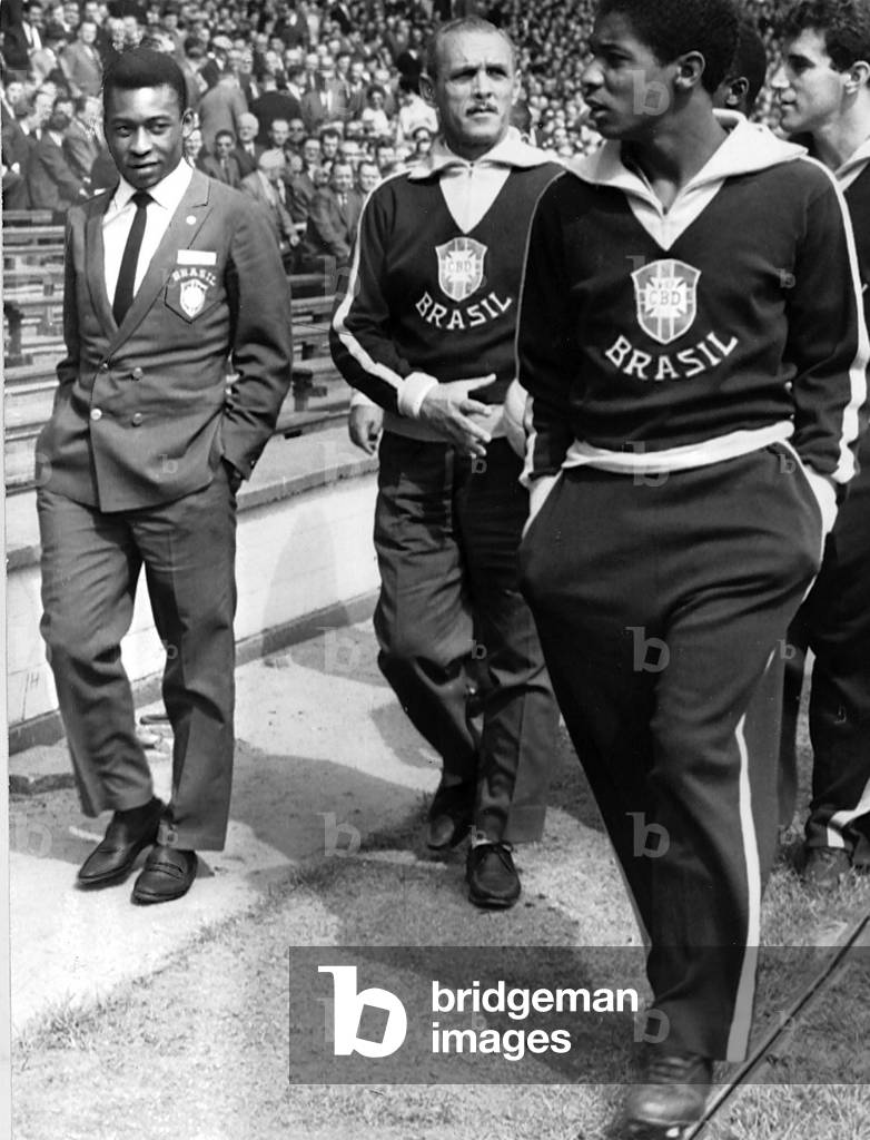 Pele Brazilian football player (L) in team blazer with fellow players 1966 (photo)