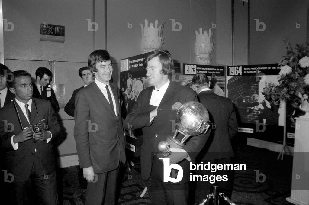 Mr. Edward Heath, leader of the opposition, congratulates Kent Gavin, Daily Mirror, after he was named British Press photographer of the year at the Europa Hotel, London. December 1969