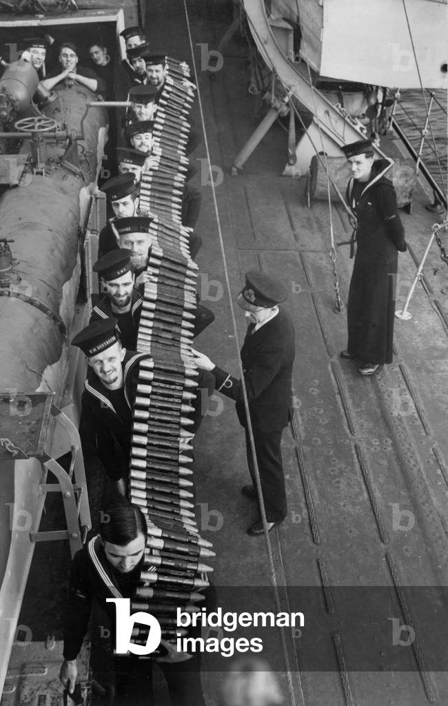 Pom Pom shells being passed to the platforms from the shell rooms by Royal Navy sailors in the Second World War, circa February 1942