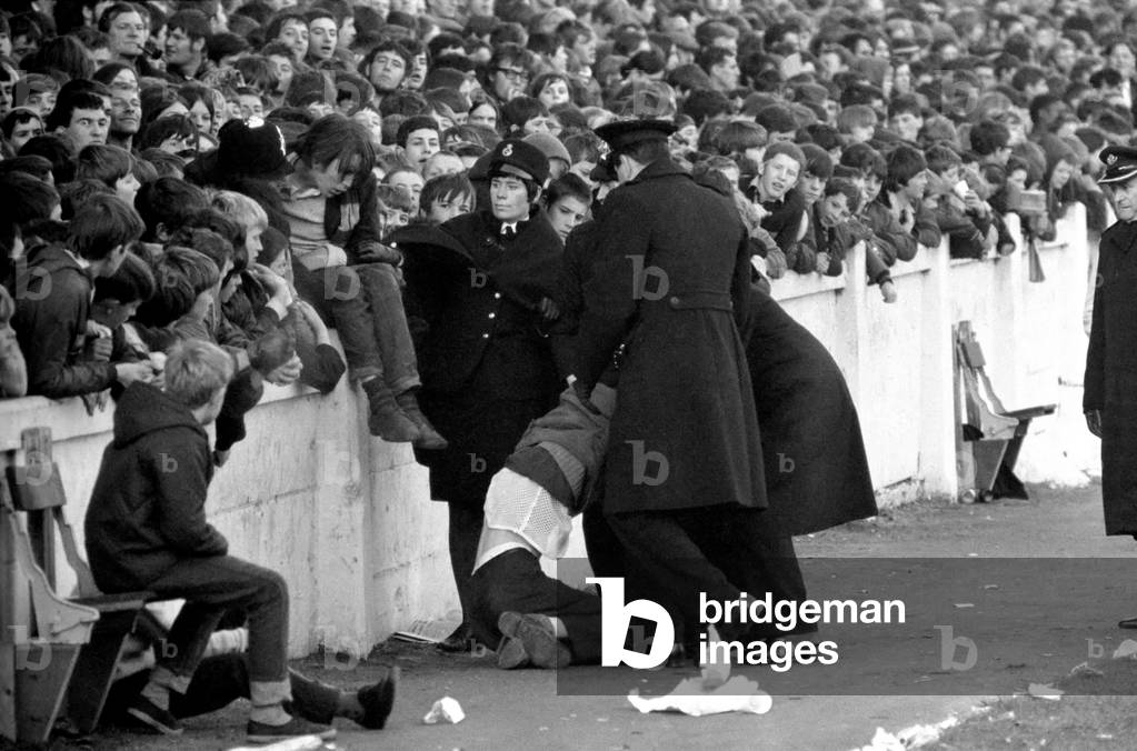English League Division One match at Highfield RoadCoventry City 1 v Manchester United 2. Troublemaker is escorted out of the ground by policeNovember 1969 (photo)