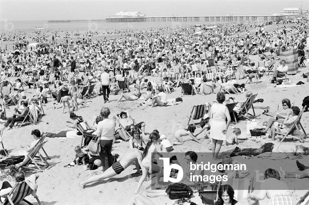 Crowds pack the Central beach at Blackpool on a hot summer's day, Lancashire. 16th July 1972 (b/w photo)