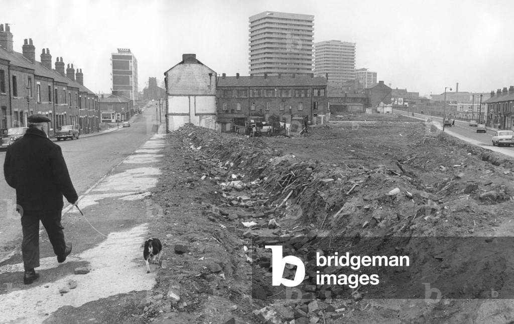 One of the open spaces that has appeared in the Hillfields area of Coventry where houses have been demolished. The local residents think the area should be landscaped. The ground has been earthed up to prevent unauthorised parking. 31st March 1971 (b/w photo)