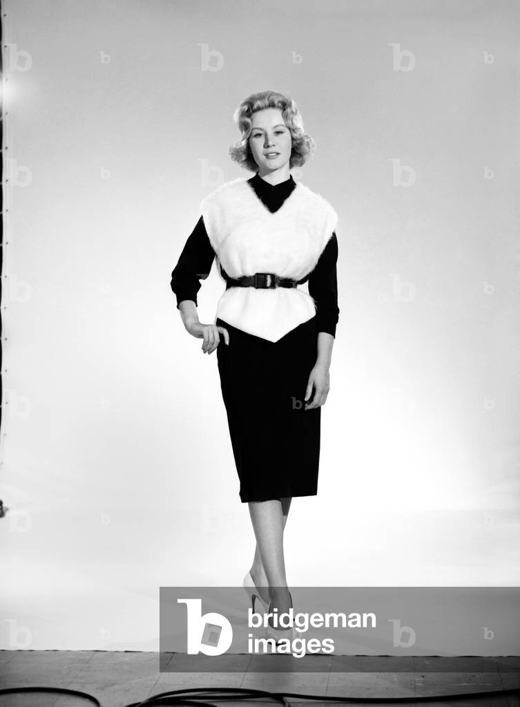 Puts hairs on your chest. Clothing: Fashion: Blouse. Woman wearing white furry blouse, April 1960 (b/w photo)