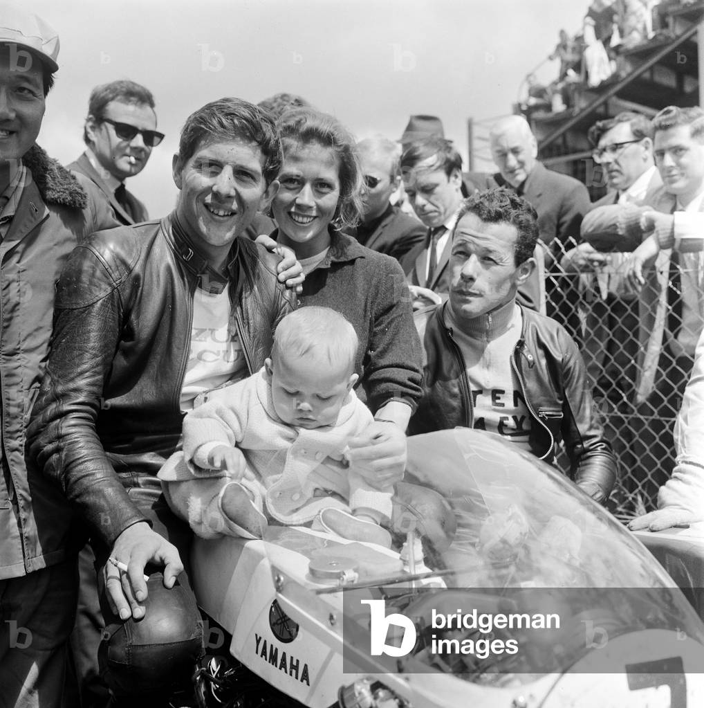 Isle of Man TT Races - Junior International. Winner Phil Read with his family after the race. 16th June 1965 (b/w photo)