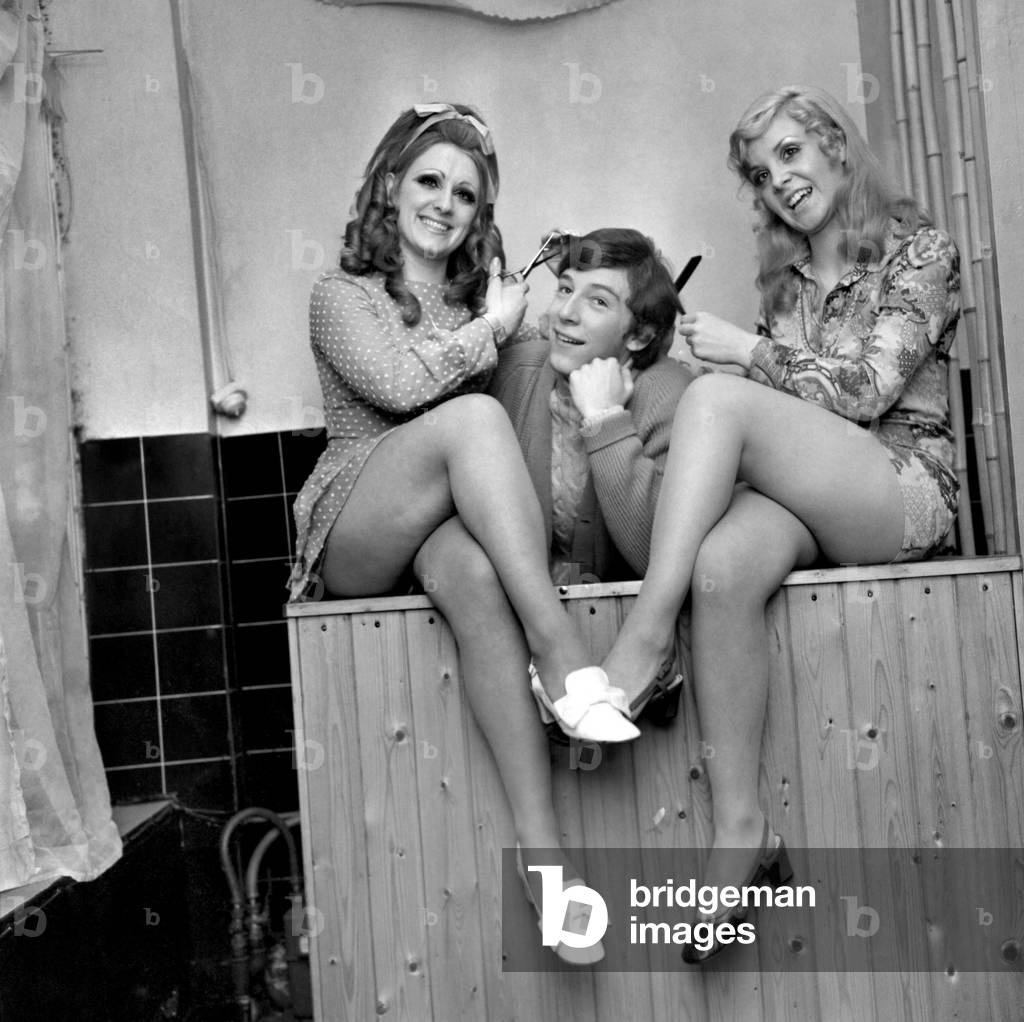 A ladies hair dressing salon in Eaton-road, West Derby, Liverpool, with a difference, run by partners Go-Go girls Ellie Heston 20, of West Derby, and June Kitson, 20, of Huyton, Liverpool, who now cut and style mens hair. Decemebr 1969
