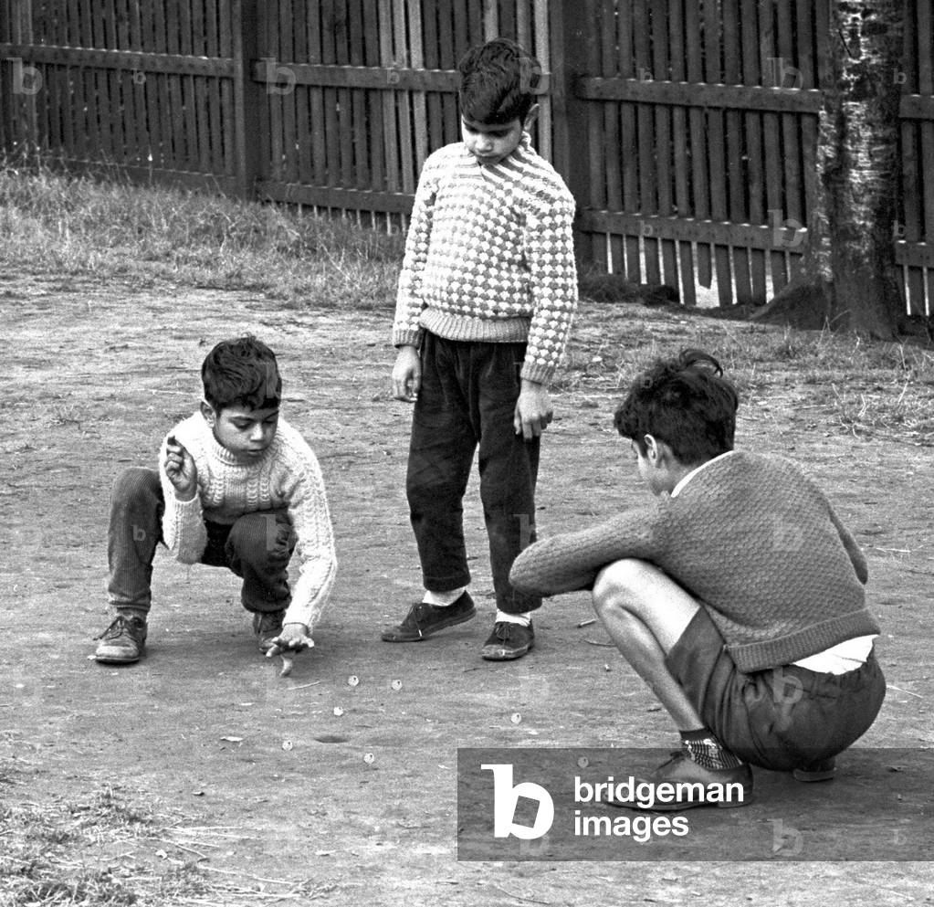 Children enjoy a game of marbles in Hillfields, Coventry, 17th August 1962 (b/w photo)