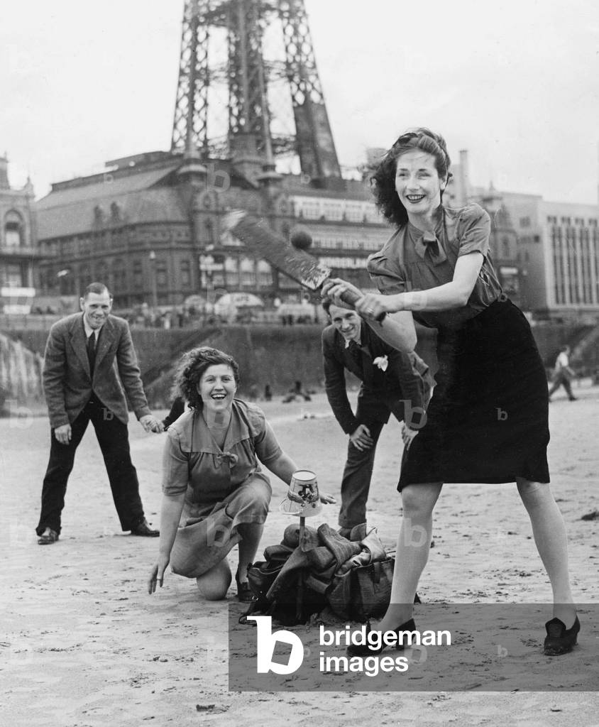 Holidaymakers play a game of cricket on the sands at Blackpool Beach cricket, 3rd August 1946 (b/w photo)
