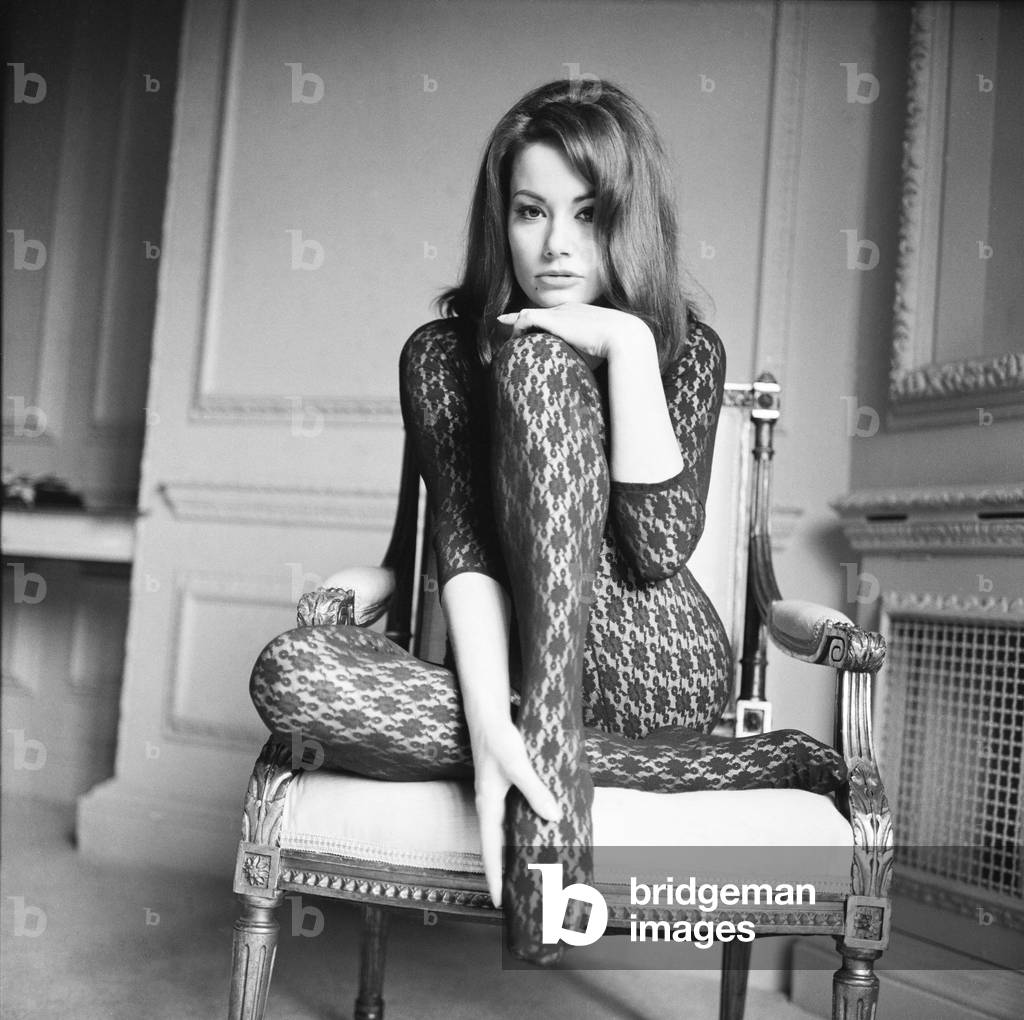 Parisienne actress Claudine Auger who will play Domino in the James Bond film Thunderball, seen here during an interview with the Daily Mirror show business reporter Donald Zec. 17th February 1965 (b/w photo)