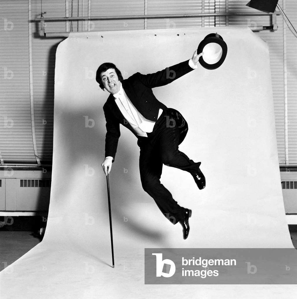 Disc Jockey Terry Wogan in studio looking all dressed up for a night on the town, wearing top hat and tails, December 1972 (b/w photo)