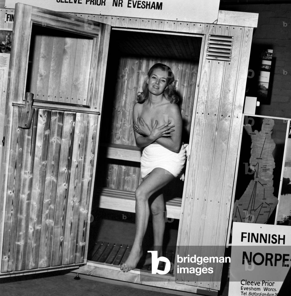 The 12th Annual Camping and Outdoor Life and Travel Exhibition at Empire Hall in Olympia, London,
Miss Wendy Pattenden (26) from Bournemouth trying out a Finnish Norpe-Sauna bath which sells for £430. 
December 1969