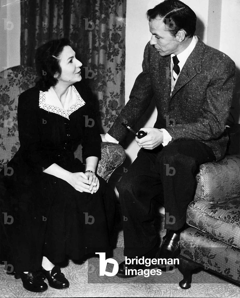 Frank Sinatra singer and actor with Trudie Morris President founder and secretary of the Sinatra Fan Club in his room at the Washington Hotel London. December 1951