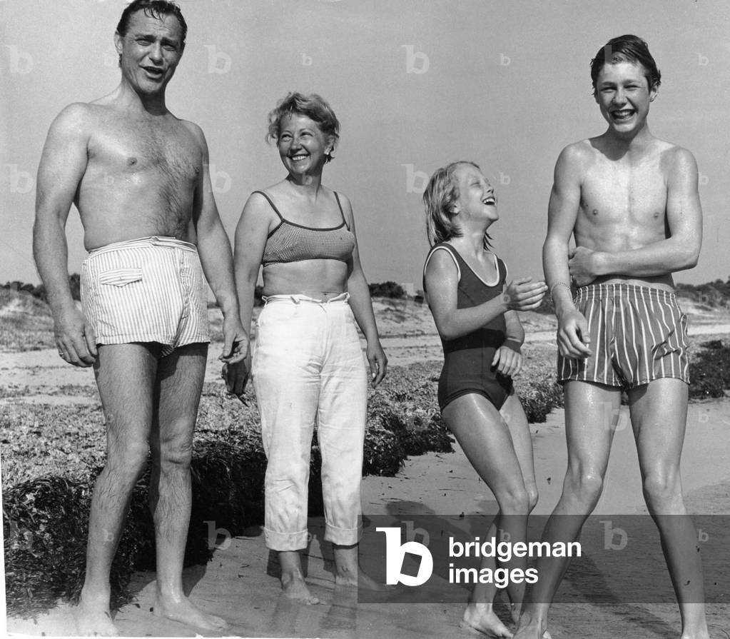 Film actor Richard Todd pictured with his wife Catherine and their two children Fiona (11) and Peter (15) on a sun drenched beach in Ibiza 28th May 1967 (b/w photo)