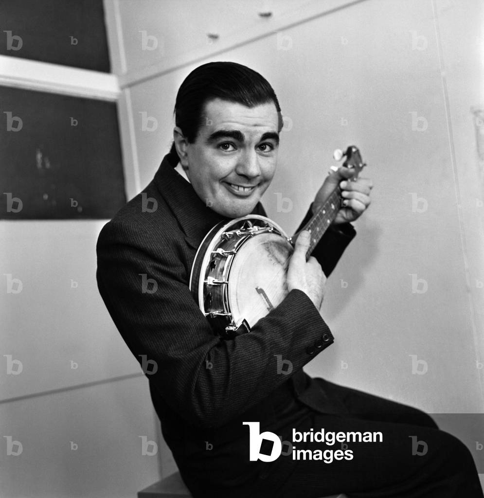 Man wearing a suit playing the Banjo. 
October 1969