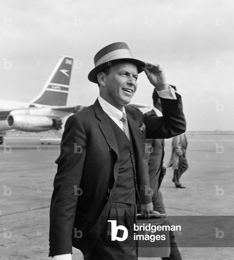 Frank Sinatra seen here arriving at Heathrow airport in the summer of 1961 (b/w photo)
